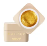 Tarro abierto de gel dorado NAILSUP Metallic Artistic Gold de 5 g con la tapa al lado.